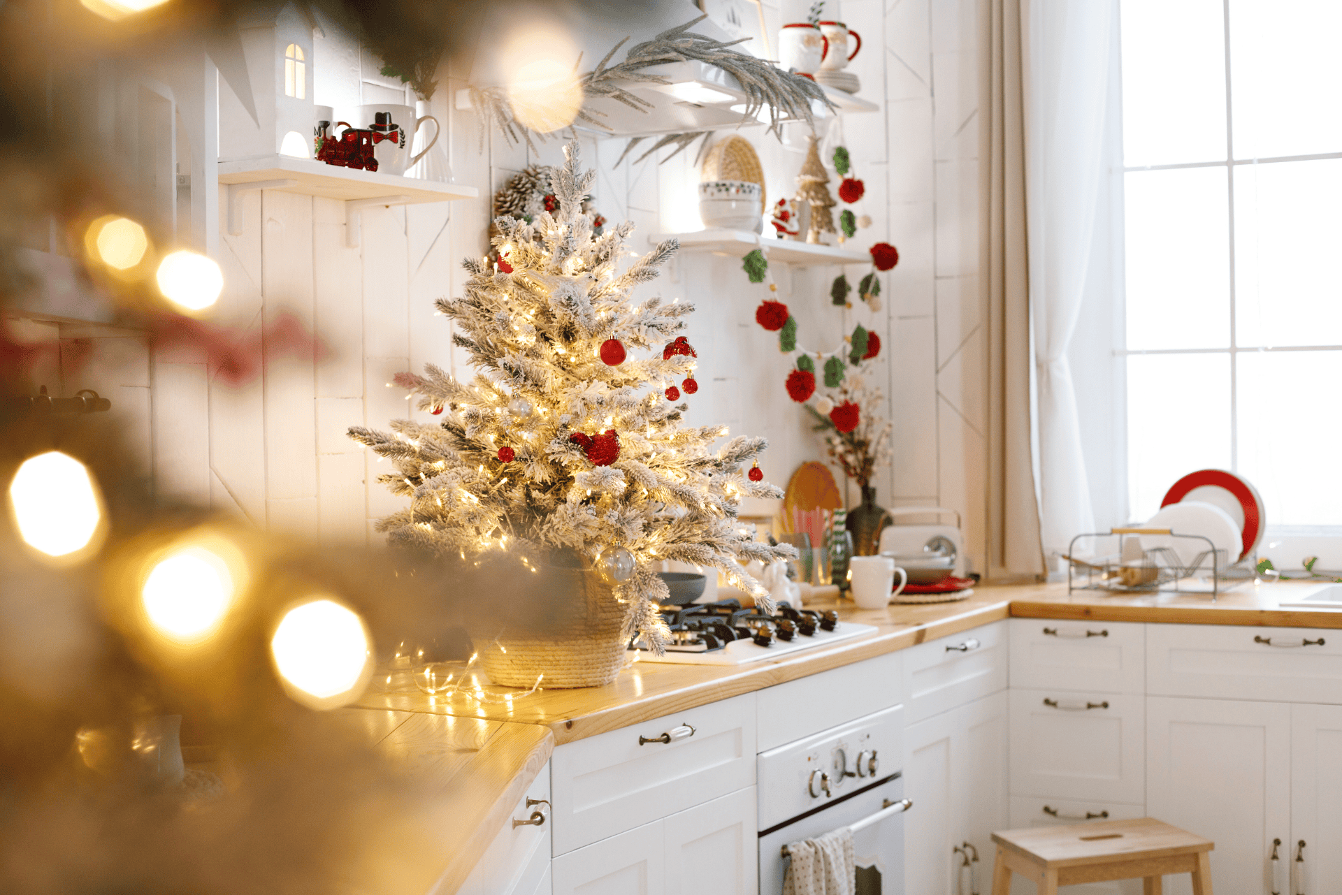 kitchen decorated for the holidays with a Christmas tree and lights in the foreground